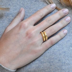 Alternative view of Neolithic hand-hammered cross over ring in 18k gold